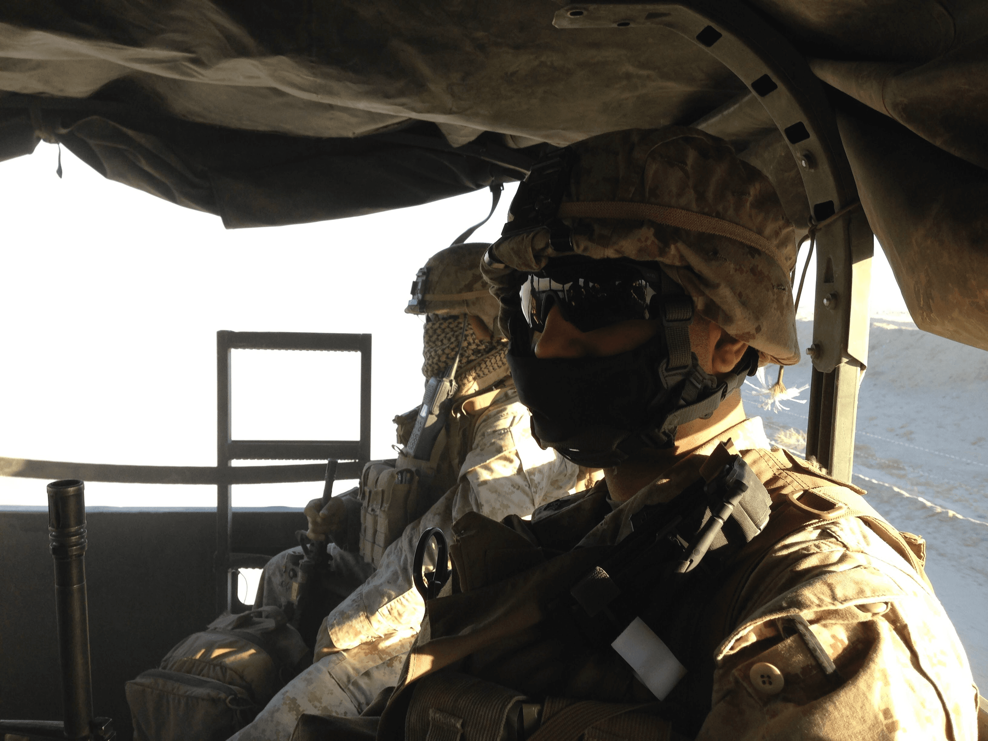Navy Hospital Corpsman in desert MARPAT with Marines during mounted patrol
