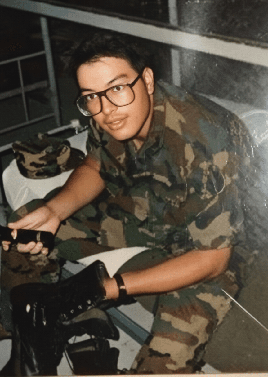 Army medical technician working at operational desk in combat fatigues